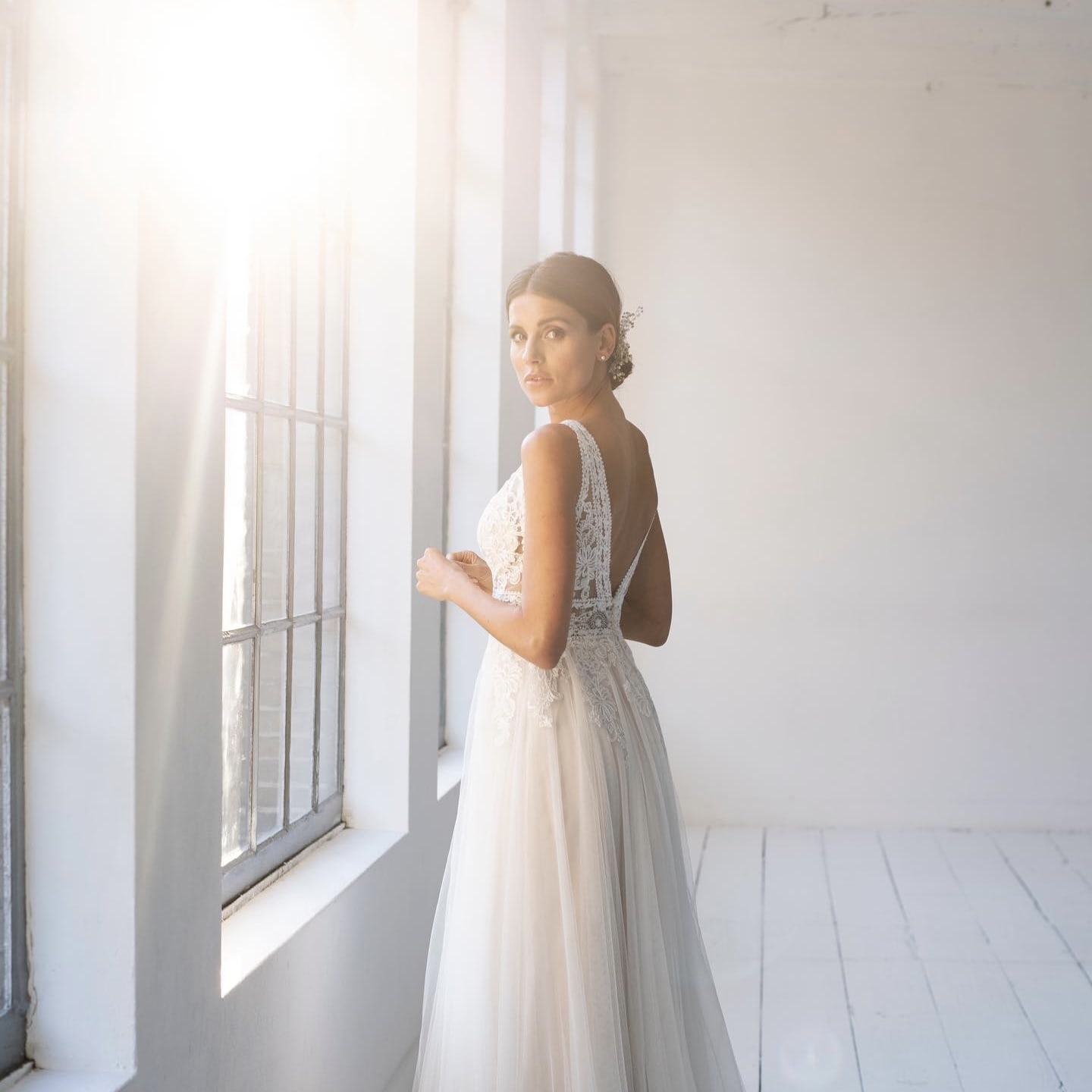 bride in window with low sun light